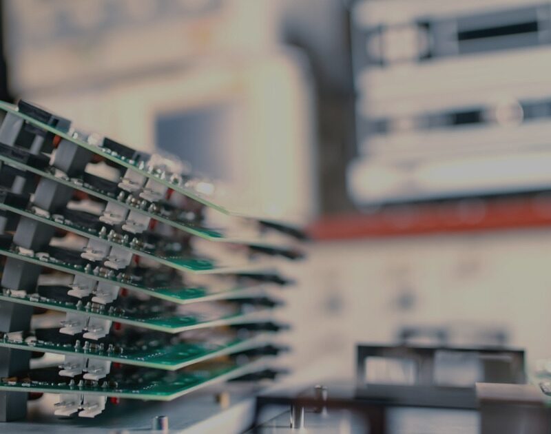 Close up picture of circuit boards stacked and ready for production