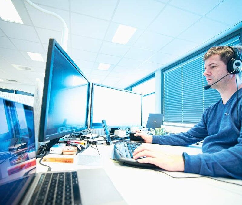 Picture of Test Engineer in front of labtop and pc monitor